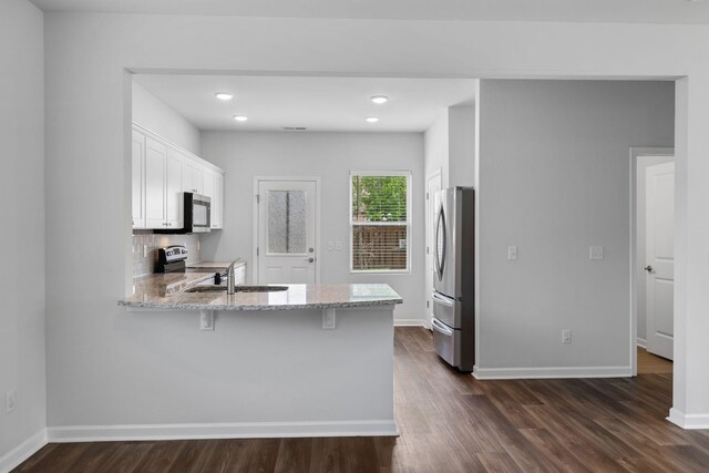 3021 Posada Ct, Spring Hill, TN 37174 - kitchen featuring white cabinetry, dark wood-style flooring, light stone countertops, and stainless steel appliances