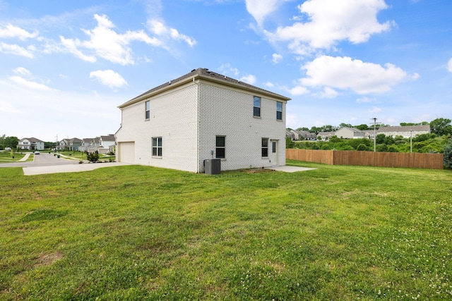 3021 Posada Ct, Spring Hill, TN 37174 - rear view of property featuring fence, an attached garage, central air condition unit, a lawn, and driveway