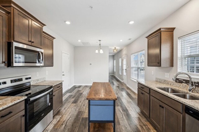 100 Bergen Dr, Spring Hill, TN 37174 - kitchen featuring light stone counters, a sink, dark wood finished floors, and stainless steel appliances