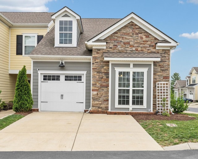 100 Bergen Dr, Spring Hill, TN 37174 - view of front of property with concrete driveway, a shingled roof, stone siding, and a garage