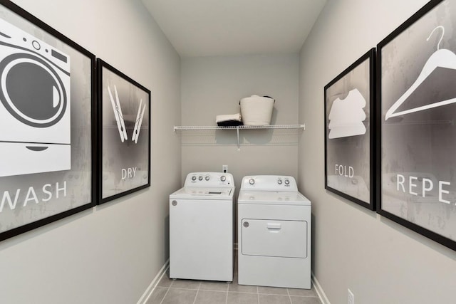 washroom featuring laundry area, baseboards, light tile patterned floors, and separate washer and dryer