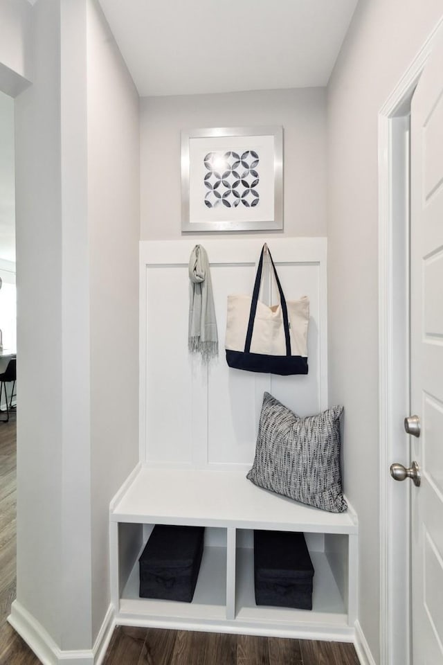 mudroom featuring baseboards and wood finished floors