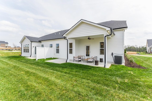 rear view of property featuring ceiling fan, a patio, an outdoor living space, central AC unit, and a yard