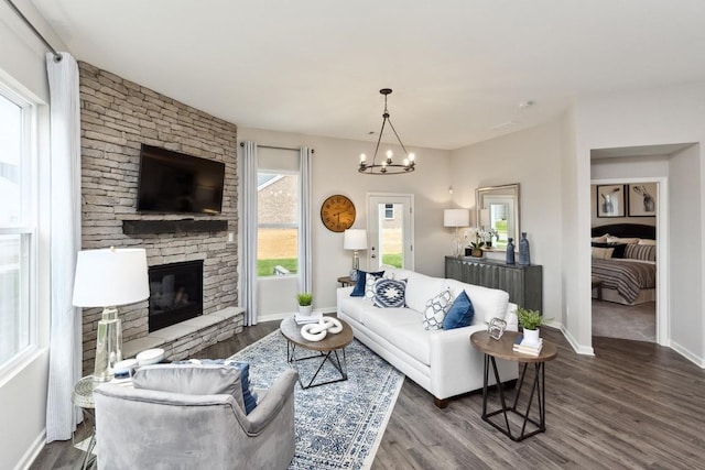 living area with baseboards, a fireplace, and dark wood-style floors