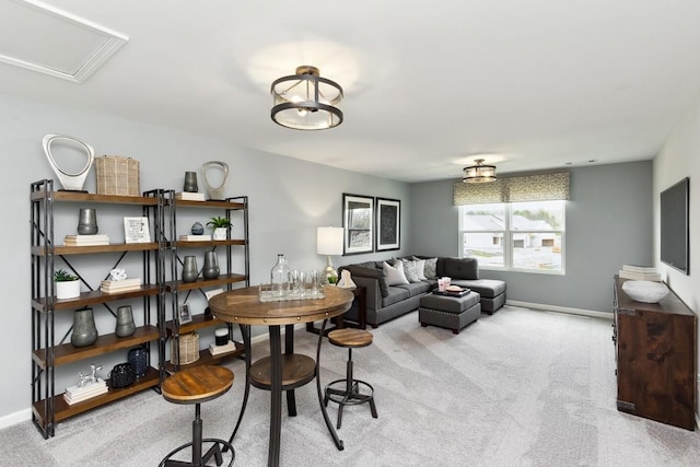 carpeted living room with baseboards