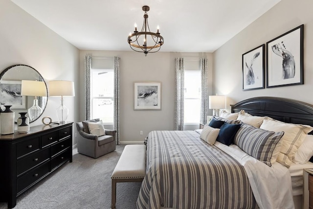 bedroom featuring baseboards, a notable chandelier, light carpet, and multiple windows