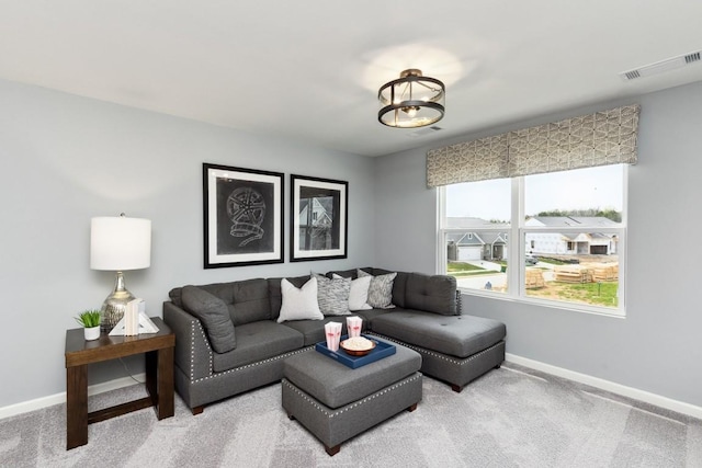 living room featuring carpet flooring, baseboards, and visible vents