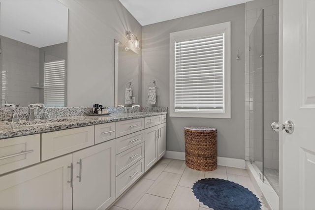 6328B Columbia Ave, Nashville, TN 37209 - bathroom with double vanity, baseboards, a tile shower, and a sink