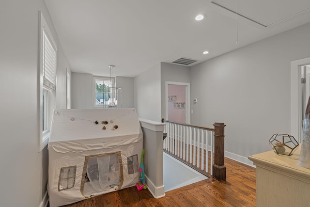 6328B Columbia Ave, Nashville, TN 37209 - hallway featuring visible vents, wood finished floors, baseboards, attic access, and an upstairs landing