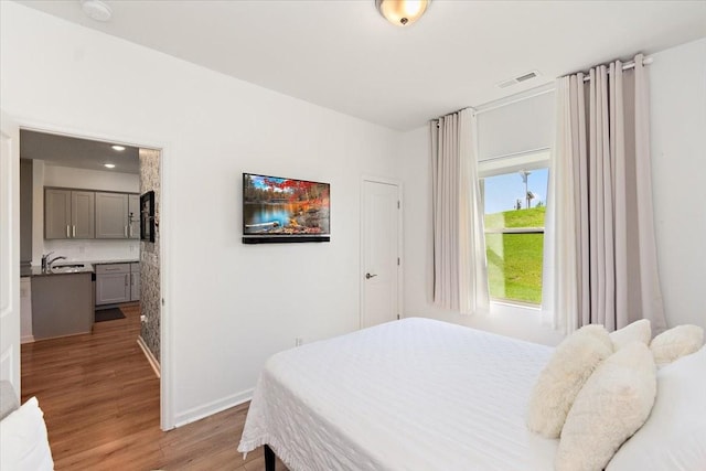 3294 Holiday Ln, Columbia, TN 38401 - bedroom featuring a sink, baseboards, light wood-style flooring, and visible vents