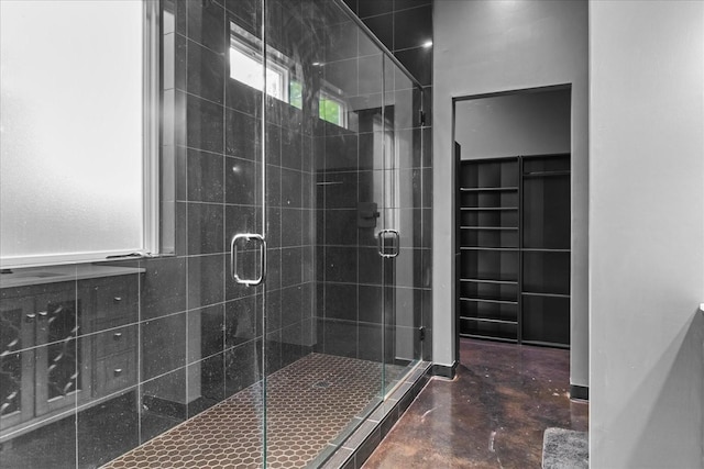 8360 Pinewood Rd, Lyles, TN 37098 - full bath featuring concrete floors, a walk in closet, and a shower stall