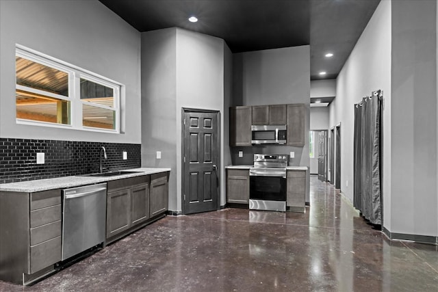 8360 Pinewood Rd, Lyles, TN 37098 - kitchen featuring backsplash, stainless steel appliances, baseboards, and a sink