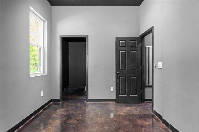 8360 Pinewood Rd, Lyles, TN 37098 - interior space featuring concrete flooring, baseboards, and multiple windows
