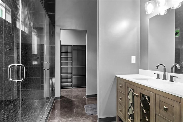 8360 Pinewood Rd, Lyles, TN 37098 - bathroom with vanity, a stall shower, finished concrete floors, and a walk in closet