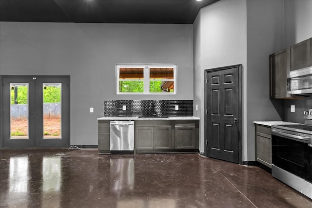 8360 Pinewood Rd, Lyles, TN 37098 - kitchen featuring decorative backsplash, a towering ceiling, appliances with stainless steel finishes, concrete flooring, and a sink