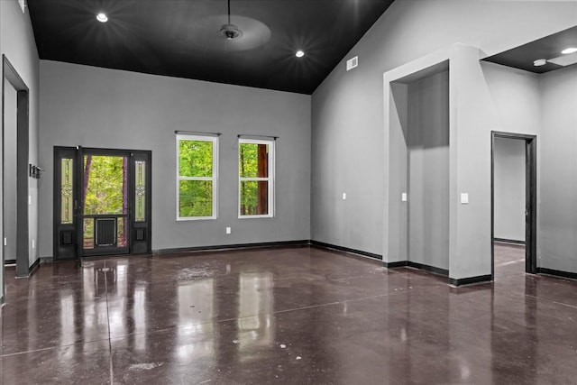 8360 Pinewood Rd, Lyles, TN 37098 - spare room featuring high vaulted ceiling, baseboards, recessed lighting, and finished concrete floors