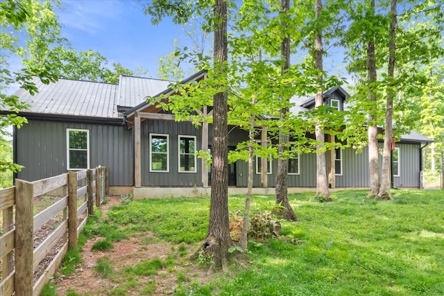 8360 Pinewood Rd, Lyles, TN 37098 - rear view of property featuring board and batten siding, fence, and a yard