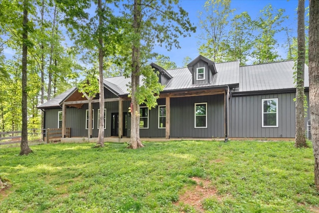 8360 Pinewood Rd, Lyles, TN 37098 - rear view of property featuring a lawn, board and batten siding, fence, and metal roof