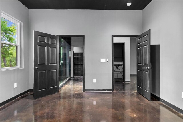 8360 Pinewood Rd, Lyles, TN 37098 - unfurnished bedroom with baseboards and concrete floors