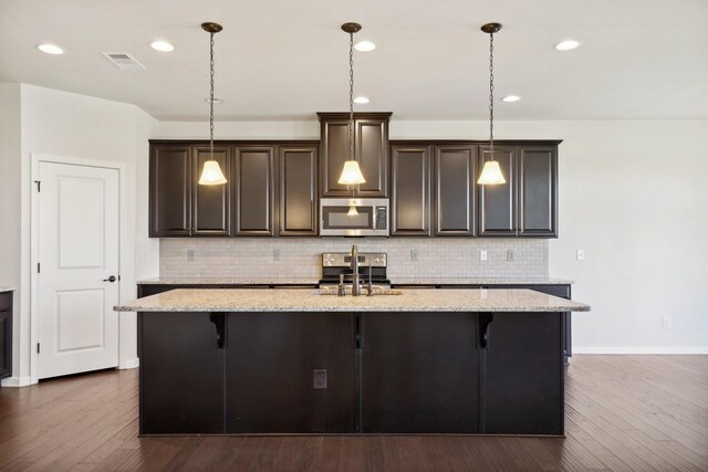 820 Turnbo Dr, Gallatin, TN 37066 - kitchen featuring a kitchen island with sink, stainless steel appliances, dark wood finished floors, and dark brown cabinets