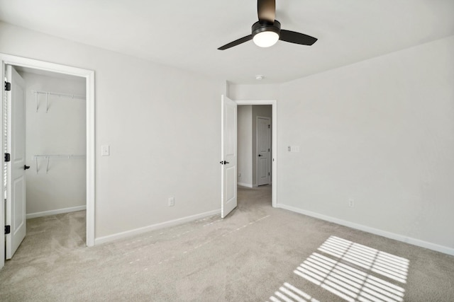 820 Turnbo Dr, Gallatin, TN 37066 - unfurnished bedroom featuring baseboards, light carpet, a walk in closet, and a closet