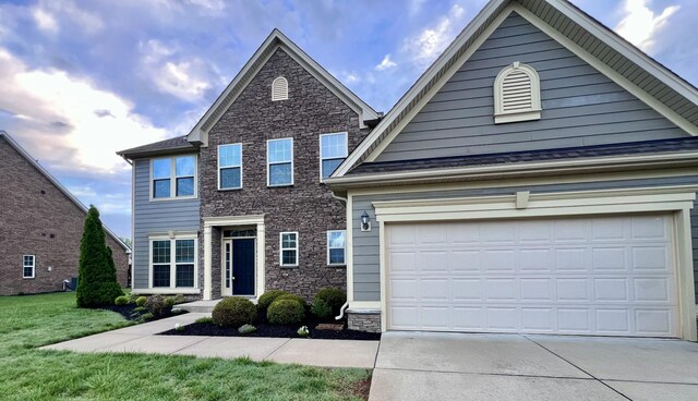 820 Turnbo Dr, Gallatin, TN 37066 - view of front of home featuring concrete driveway, a front lawn, stone siding, and a garage