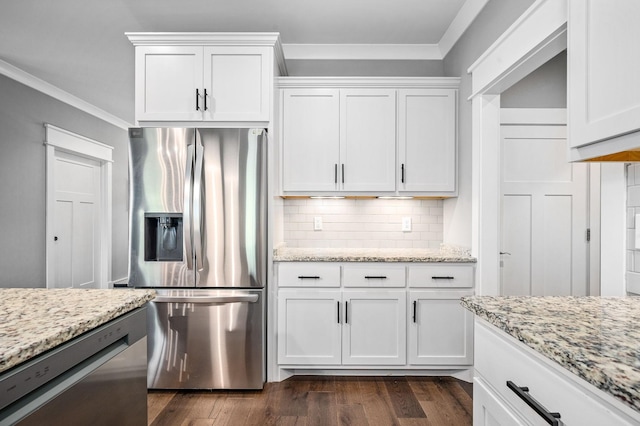 kitchen featuring appliances with stainless steel finishes, white cabinets, and ornamental molding