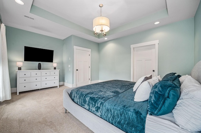 bedroom with carpet floors, visible vents, baseboards, recessed lighting, and a raised ceiling