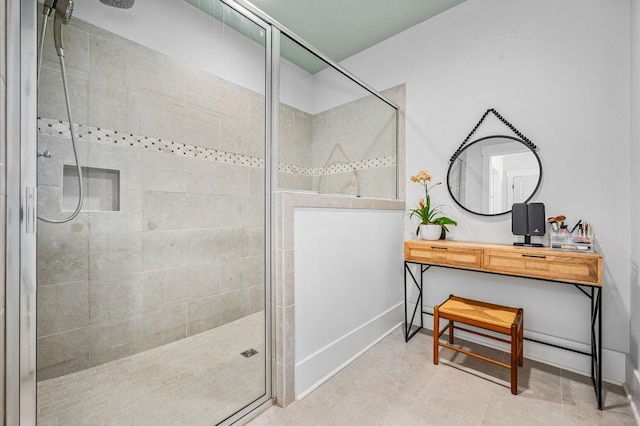 bathroom with baseboards and a shower stall