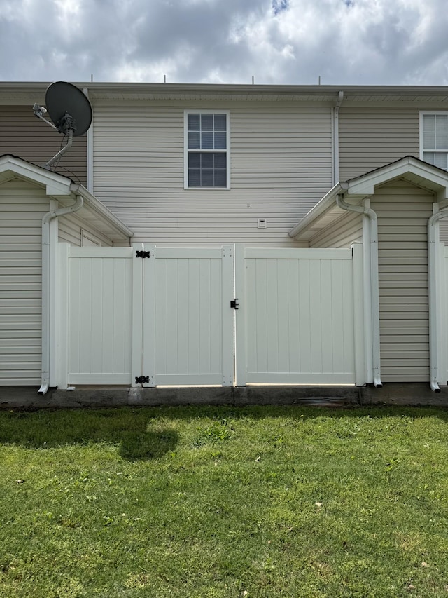 exterior space featuring a gate and a yard