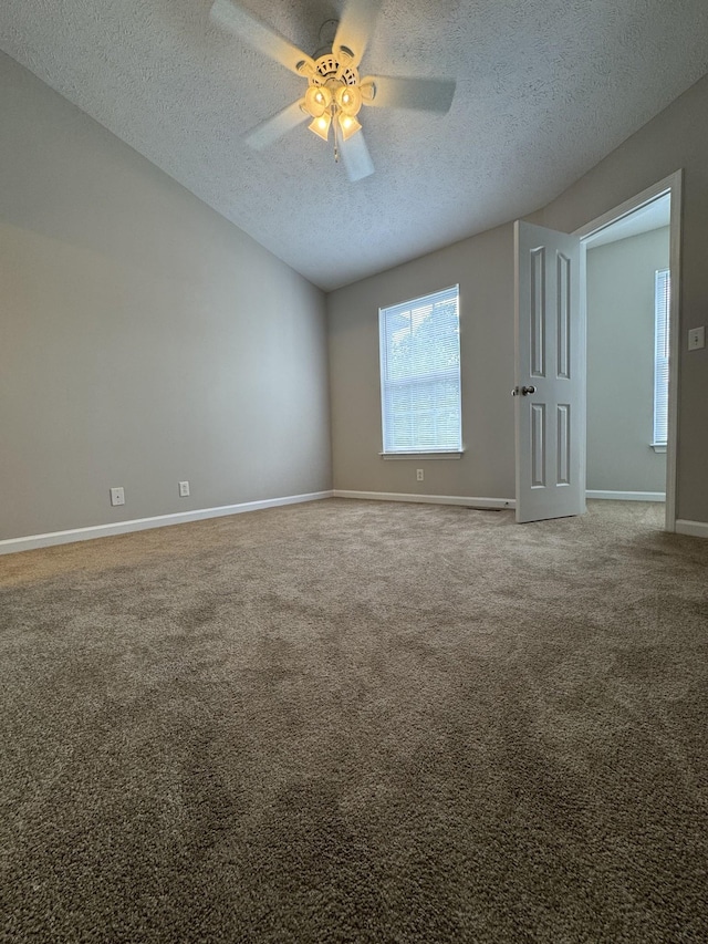 unfurnished room featuring baseboards, a ceiling fan, a textured ceiling, and carpet flooring