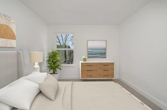 carpeted bedroom featuring baseboards