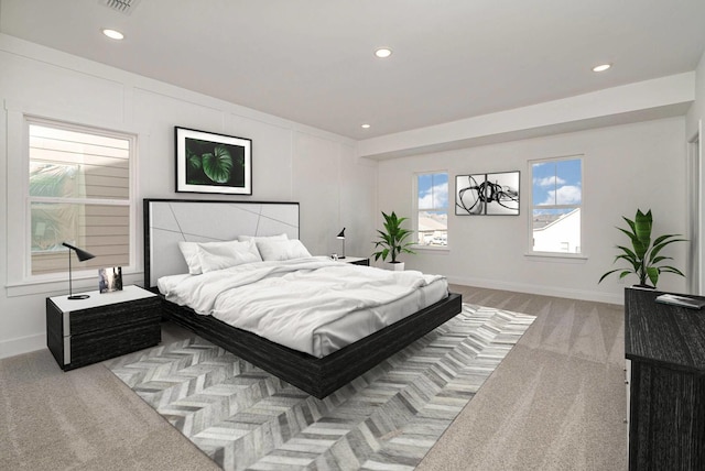 carpeted bedroom featuring baseboards and recessed lighting