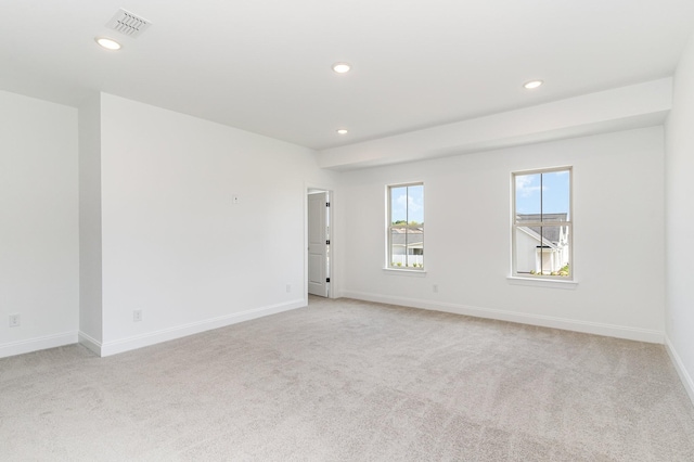 empty room featuring recessed lighting, baseboards, visible vents, and light carpet