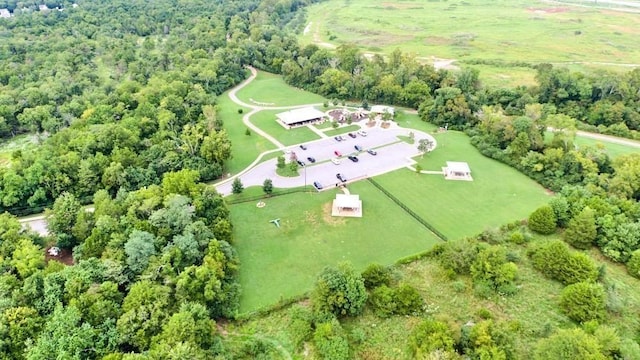 birds eye view of property featuring a wooded view
