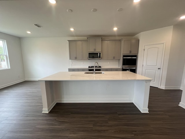 1611 Burlwood Ct, Murfreesboro, TN 37129 - kitchen featuring a large island with sink, baseboards, gray cabinetry, and stainless steel appliances