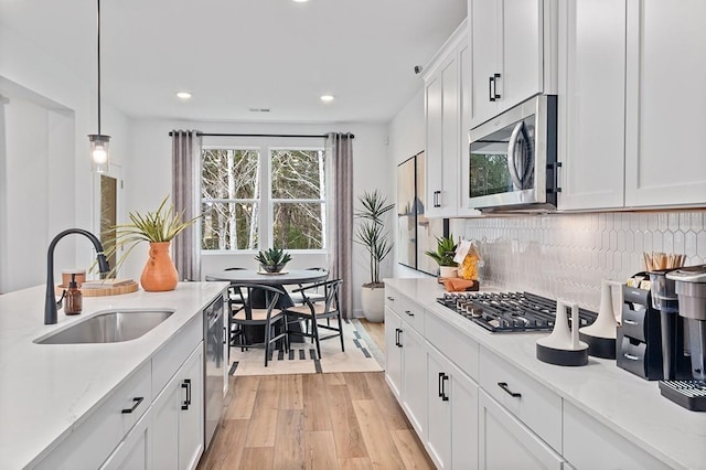 1611 Burlwood Ct, Murfreesboro, TN 37129 - kitchen featuring decorative backsplash, recessed lighting, a sink, light wood finished floors, and stainless steel appliances