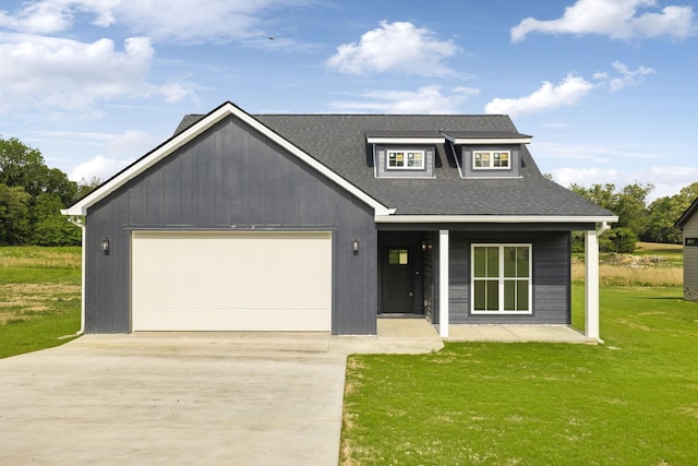 view of front facade with a garage, roof with shingles, driveway, and a front yard