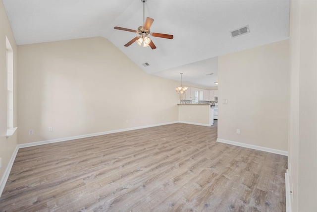 unfurnished living room with visible vents, light wood-style floors, ceiling fan with notable chandelier, and baseboards