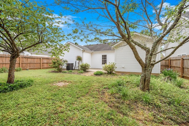rear view of house featuring a yard and fence