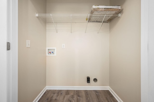 clothes washing area with baseboards, laundry area, dark wood-style floors, and hookup for a washing machine