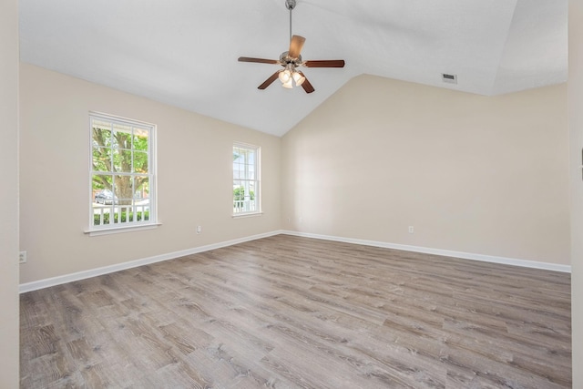 unfurnished room featuring ceiling fan, baseboards, wood finished floors, lofted ceiling, and visible vents