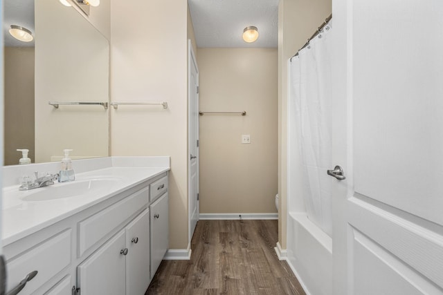 full bathroom with wood finished floors, vanity, baseboards, toilet, and a shower with shower curtain