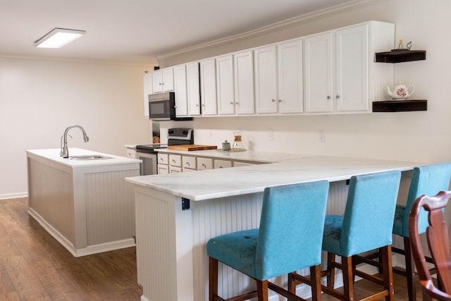 kitchen featuring open shelves, ornamental molding, a center island with sink, stainless steel electric range, and a sink