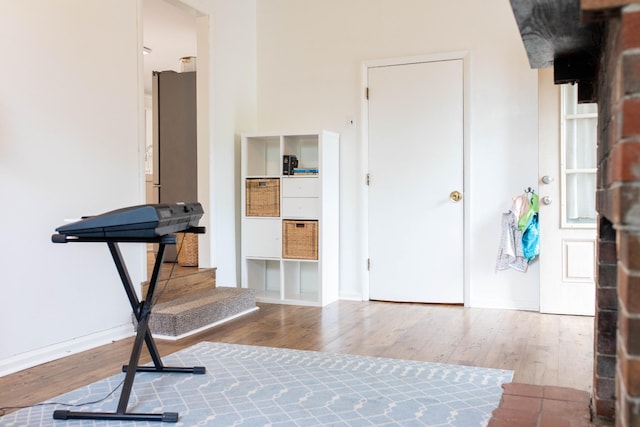 interior space featuring baseboards and wood finished floors