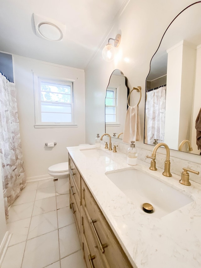 full bathroom featuring double vanity, plenty of natural light, and a sink