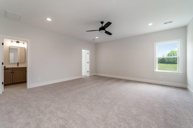 unfurnished bedroom with light colored carpet, baseboards, and visible vents