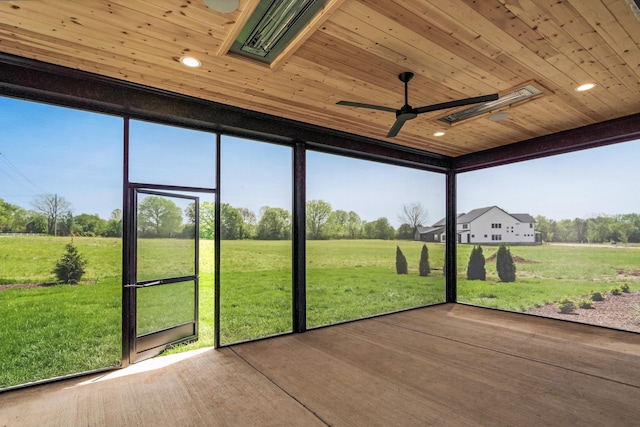 unfurnished sunroom featuring plenty of natural light and a rural view