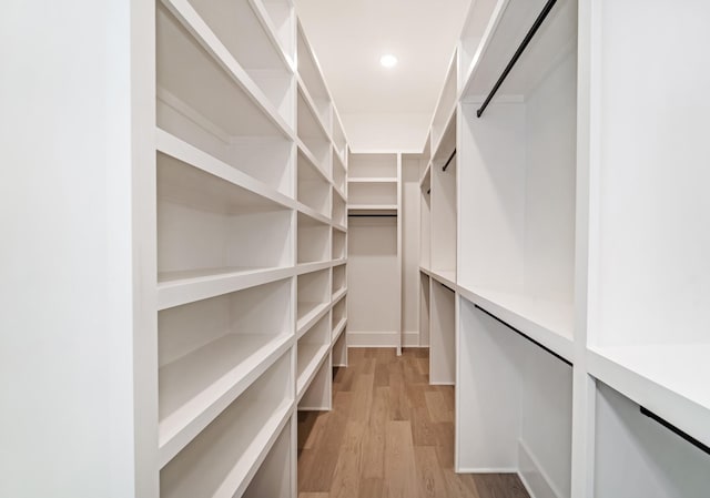 spacious closet featuring light wood-style flooring
