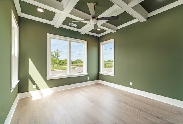 spare room with beam ceiling, wood finished floors, and coffered ceiling